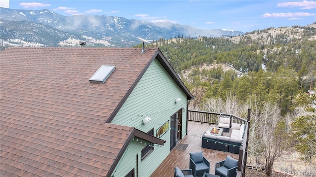 288 Spring Vly, Bailey, CO 80421 - view of side of property featuring roof with shingles and a deck with mountain view