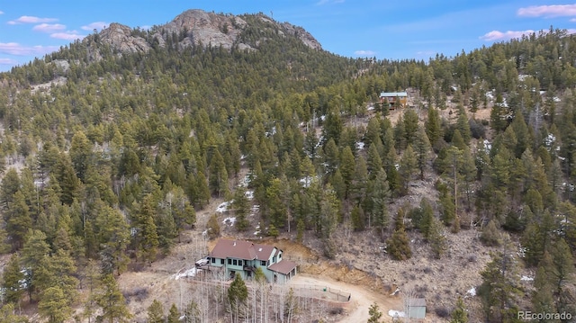 288 Spring Vly, Bailey, CO 80421 - view of property location with a heavily wooded area and a mountainous background