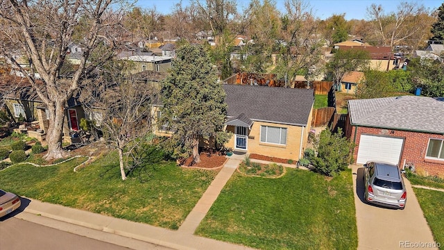 4530 S Pennsylvania St, Englewood, CO 80113 - ranch-style home featuring an attached garage, concrete driveway, a residential view, and a front yard