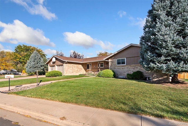 view of front facade featuring driveway, a front yard, brick siding, and an attached garage