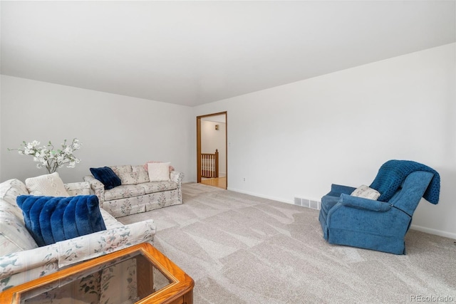 carpeted living room with visible vents and baseboards