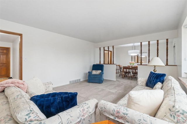 living room with carpet flooring, baseboards, and visible vents