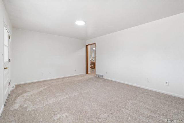 unfurnished room featuring light carpet, visible vents, and baseboards