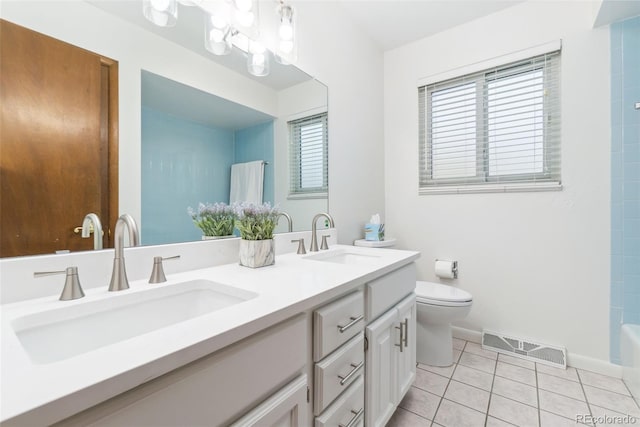 bathroom with a sink, visible vents, toilet, and tile patterned floors