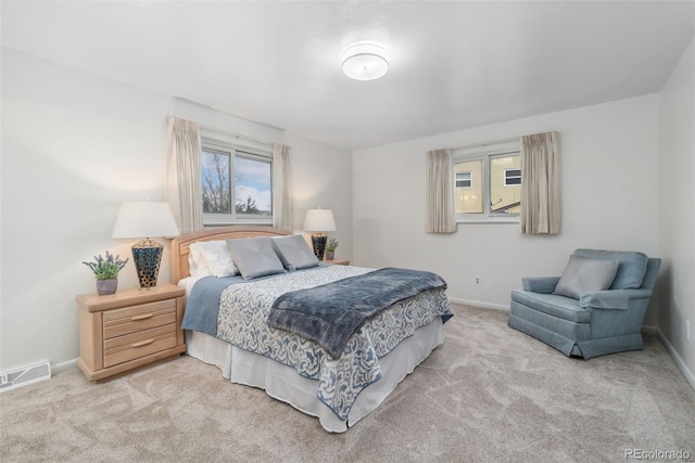 carpeted bedroom with multiple windows, baseboards, and visible vents