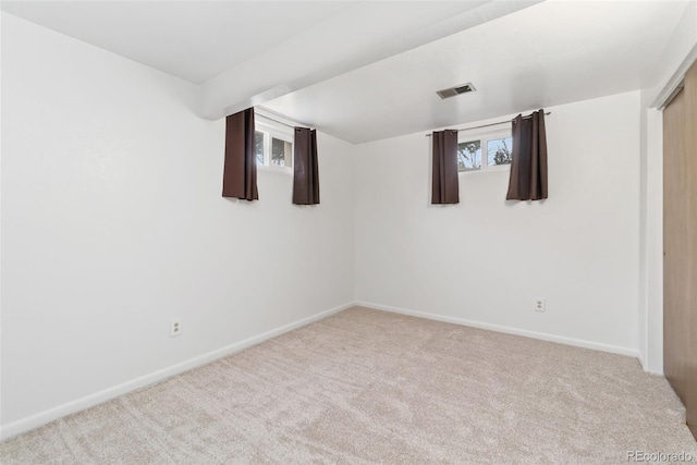 below grade area with visible vents, baseboards, and carpet