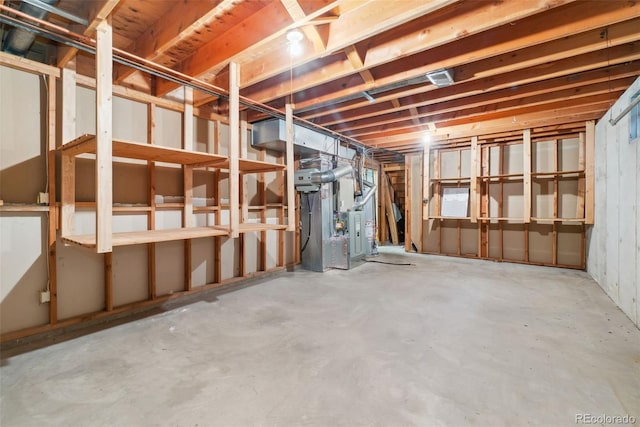 unfinished basement featuring heating unit