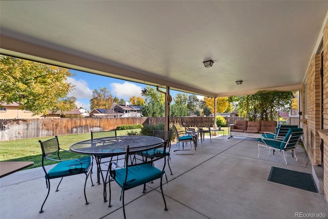 view of patio with outdoor dining space, a fenced backyard, and an outdoor hangout area