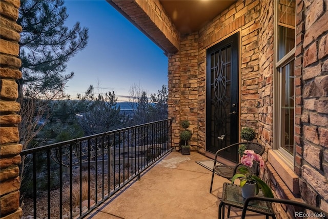 view of balcony at dusk