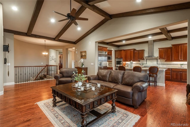 living room with lofted ceiling with beams, baseboards, dark wood finished floors, and a ceiling fan