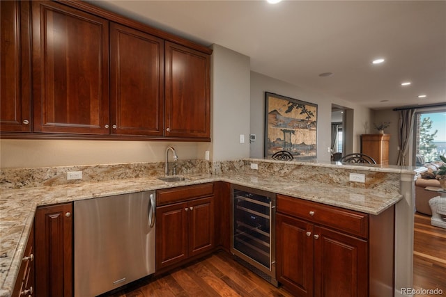 kitchen featuring dark wood finished floors, a peninsula, a sink, wine cooler, and dishwasher