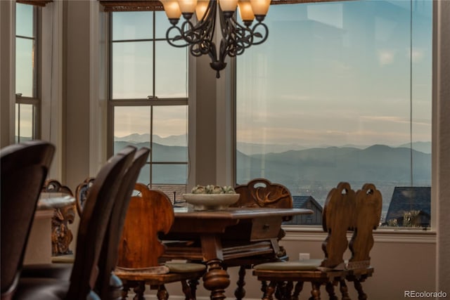 dining space featuring a mountain view and a chandelier