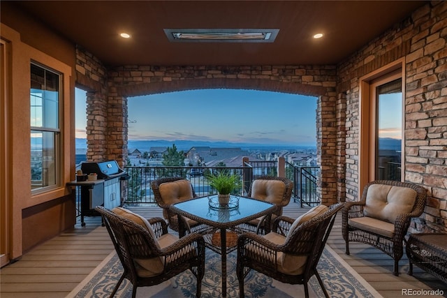 balcony at dusk with area for grilling