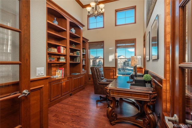 office space with wainscoting, ornamental molding, an inviting chandelier, and dark wood-style flooring