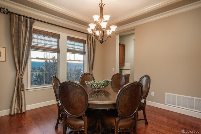 dining room with visible vents, dark wood-type flooring, baseboards, ornamental molding, and a notable chandelier