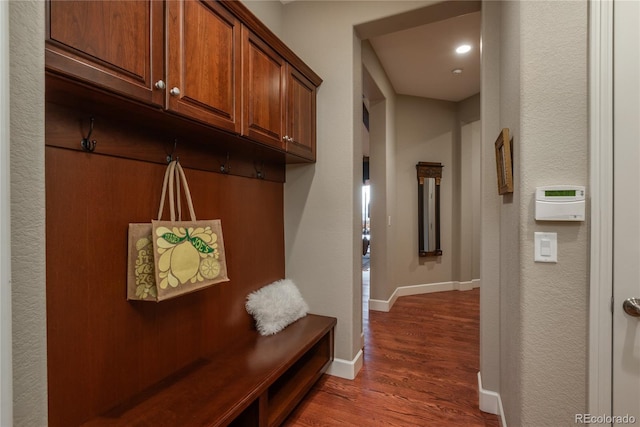 mudroom featuring wood finished floors and baseboards