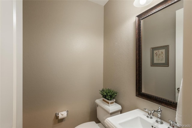 bathroom featuring toilet and a sink