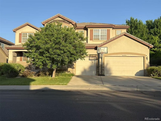 6035 S Paris St, Englewood, CO 80111 - view of front of house with a tile roof, driveway, and stucco siding