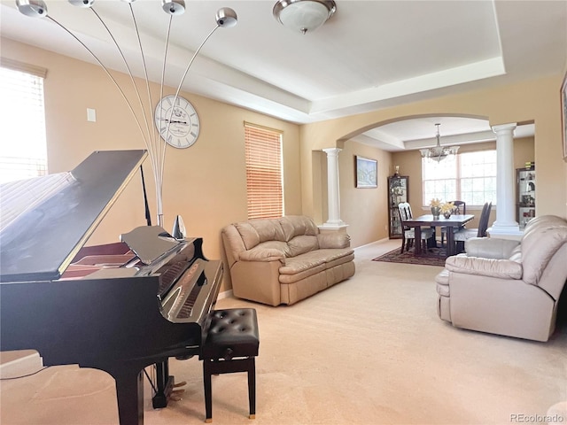 6035 S Paris St, Englewood, CO 80111 - living area featuring decorative columns, arched walkways, a chandelier, and carpet floors