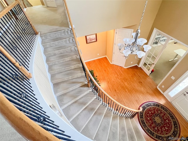 6035 S Paris St, Englewood, CO 80111 - stairs with wood finished floors and a chandelier