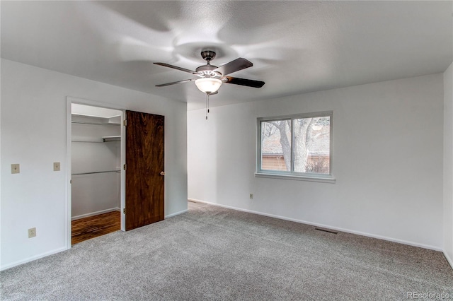 unfurnished bedroom with light colored carpet, ceiling fan, and a closet