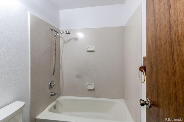 bathroom featuring shower / tub combination and toilet