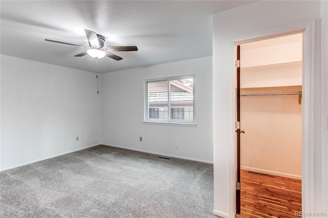 unfurnished bedroom featuring a closet, ceiling fan, and carpet flooring