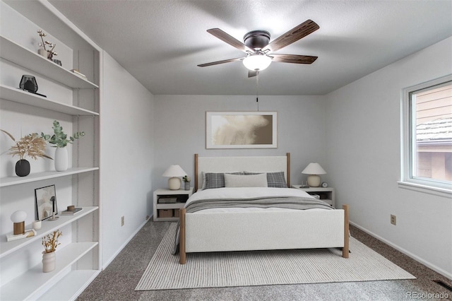 bedroom featuring a ceiling fan, carpet, a textured ceiling, and baseboards