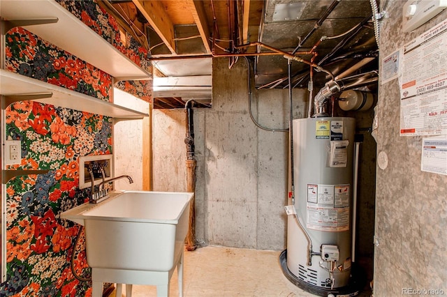 utility room with gas water heater and a sink