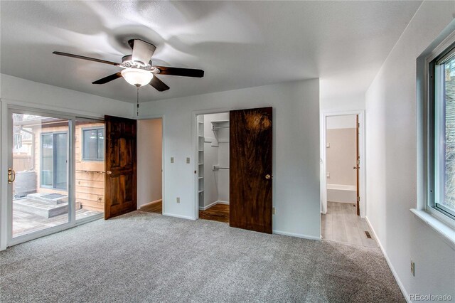 53 S Eagle Cir, Aurora, CO 80012 - unfurnished bedroom with access to exterior, carpet flooring, and multiple windows