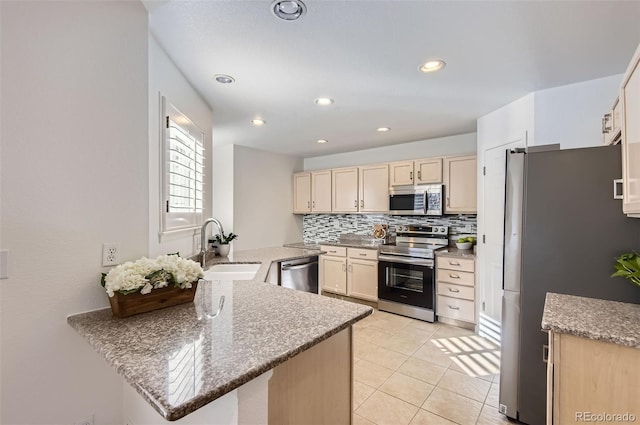 112 W Sterne Pkwy, Littleton, CO 80120 - kitchen with appliances with stainless steel finishes, a sink, backsplash, light tile patterned floors, and recessed lighting
