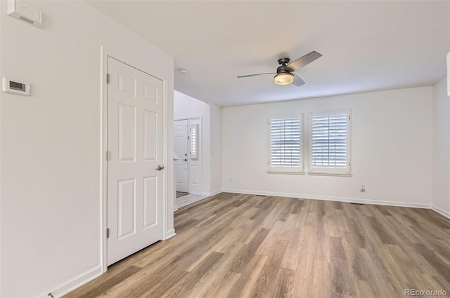 112 W Sterne Pkwy, Littleton, CO 80120 - unfurnished room with light wood finished floors, a ceiling fan, and baseboards