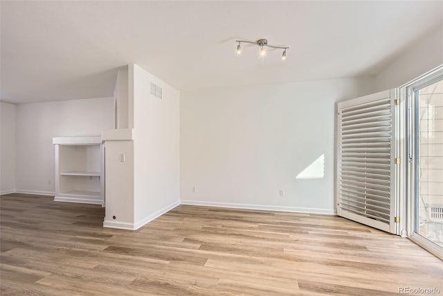 112 W Sterne Pkwy, Littleton, CO 80120 - unfurnished living room featuring light wood finished floors and baseboards