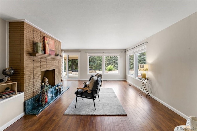 2615 Centre Ln, Colorado Springs, CO 80909 - living area featuring wood finished floors and a brick fireplace