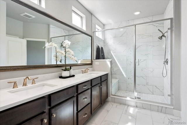 full bathroom with a sink, marble finish floor, a stall shower, and visible vents