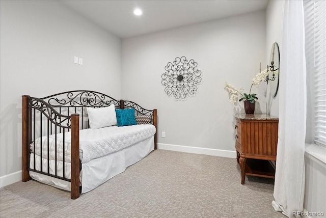 carpeted bedroom featuring baseboards