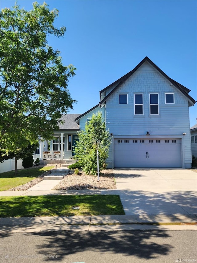 4628 Mt Shavano St, Brighton, CO 80601 - view of front facade with an attached garage, concrete driveway, and a porch