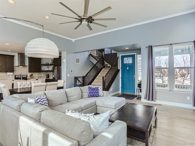 4628 Mt Shavano St, Brighton, CO 80601 - living room with crown molding, ceiling fan, stairs, recessed lighting, and light wood-style flooring