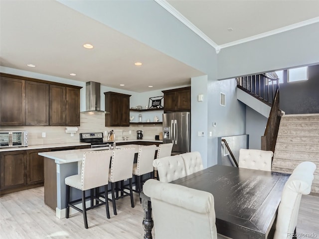 4628 Mt Shavano St, Brighton, CO 80601 - dining area with ornamental molding, stairs, light wood-style floors, and recessed lighting