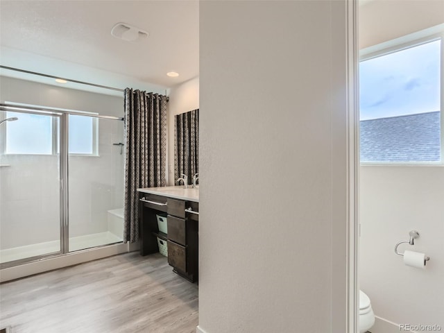 4628 Mt Shavano St, Brighton, CO 80601 - bathroom with a shower stall, vanity, and wood finished floors
