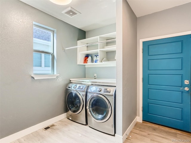 4628 Mt Shavano St, Brighton, CO 80601 - laundry area with washer and dryer and light wood-style flooring