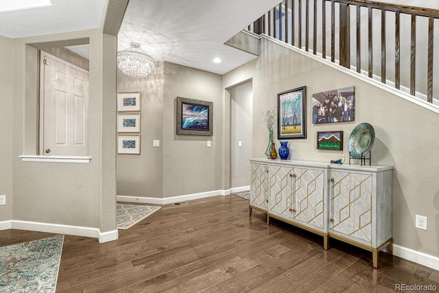6470 Amur Ct, Castle Rock, CO 80108 - hallway featuring a textured wall, wood finished floors, a chandelier, and baseboards
