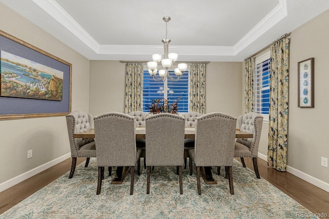 6470 Amur Ct, Castle Rock, CO 80108 - dining space with ornamental molding, a chandelier, a raised ceiling, baseboards, and wood finished floors
