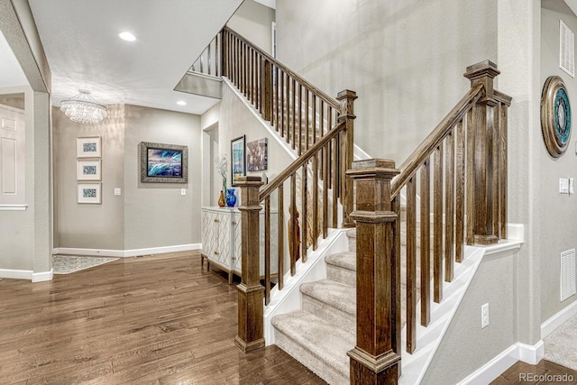 6470 Amur Ct, Castle Rock, CO 80108 - stairway with wood finished floors, baseboards, a chandelier, and recessed lighting