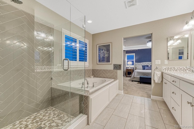 6470 Amur Ct, Castle Rock, CO 80108 - ensuite bathroom featuring vanity, a garden tub, a shower stall, tile patterned flooring, and baseboards