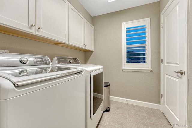 6470 Amur Ct, Castle Rock, CO 80108 - laundry room featuring cabinet space, washer and clothes dryer, baseboards, and light tile patterned floors