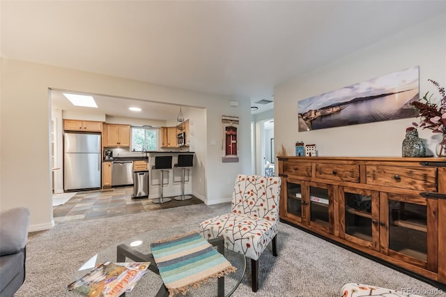 living room featuring sink and light carpet