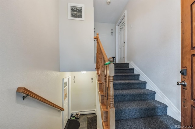 staircase with a baseboard radiator