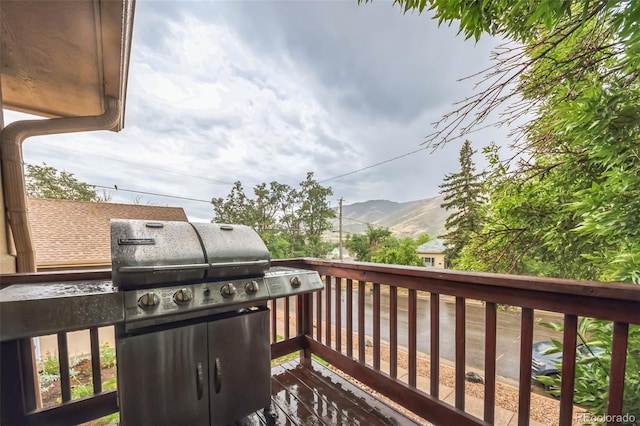 wooden terrace featuring area for grilling and a mountain view