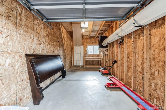 garage featuring wooden walls